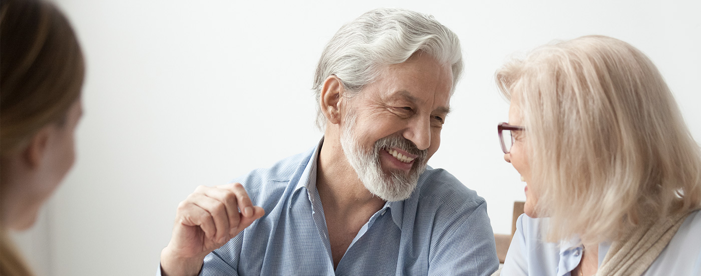 Couple talking and smiling at a desk